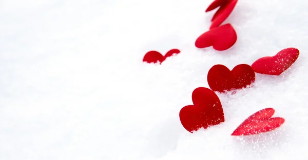 Red hearts on snow — Stock Photo, Image