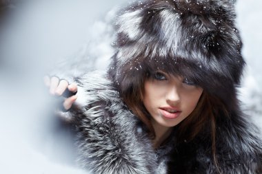 Beautiful and sexy woman in snowy winter outdoors clipart