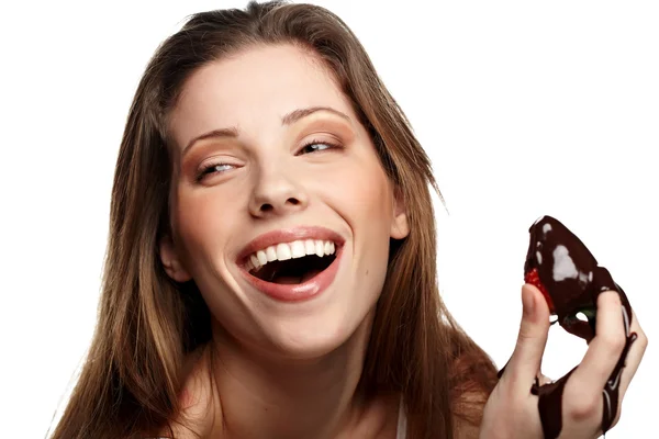 Schönes Mädchen isst eine frische rote Erdbeere mit Schokoladensauce — Stockfoto