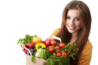 Woman holding a bag full of healthy food. shopping . clipart