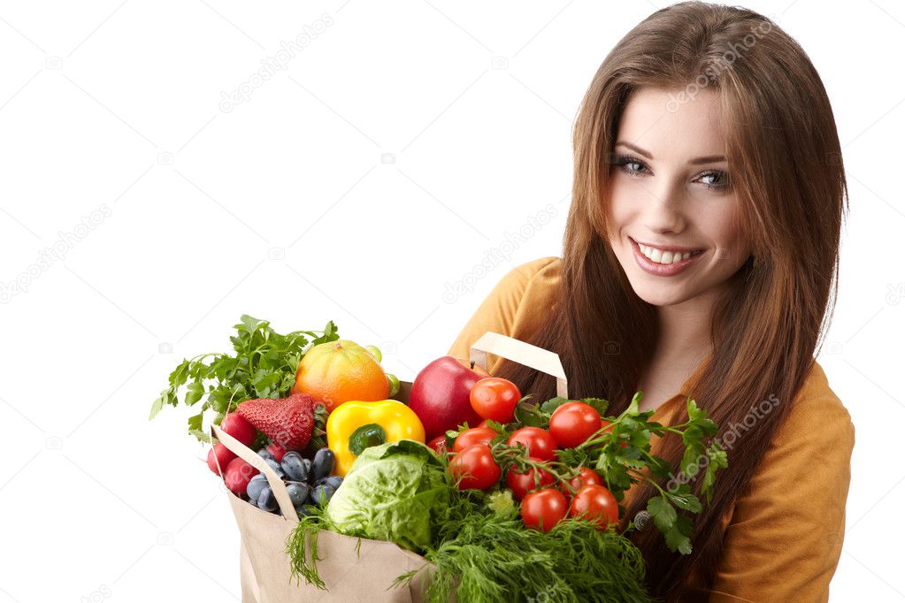 Woman holding a bag full of healthy food. shopping .
