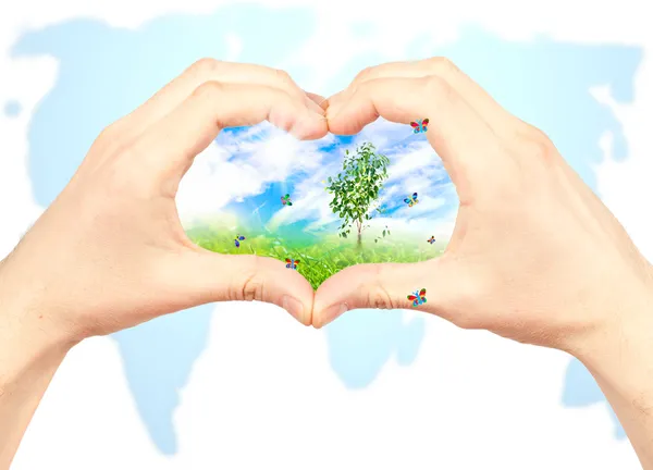 Human hand and nature on world map background. — Stock Photo, Image