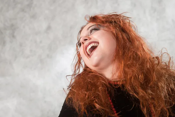 stock image Crazy young woman with matted hair, his head thrown back laughing