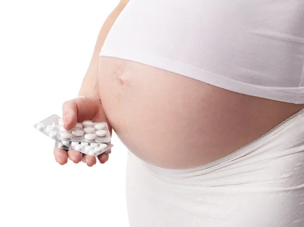 Zwangere vrouw bedrijf pillen — Stockfoto