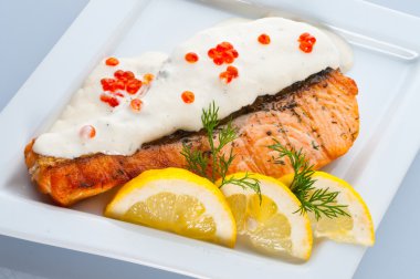 Steak from a salmon with creamy sauce and caviar clipart