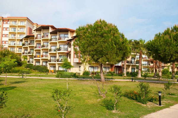 stock image Hotel with thatched cottages on the beach in the shade of palm t