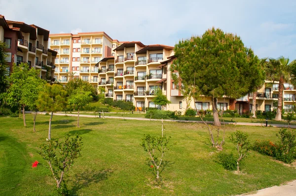 stock image Hotel with thatched cottages on the beach in the shade of palm t