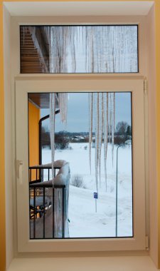 Icicles on roof in cols winter clipart