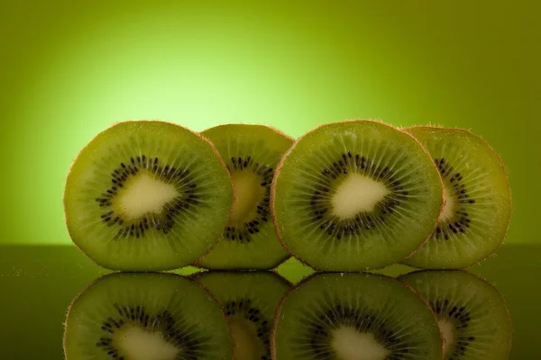 stock image Green Kiwi in row on green background