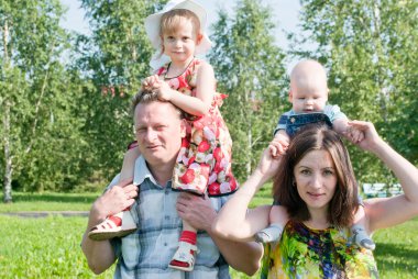 Children sit on the necks of the parents, happy family clipart