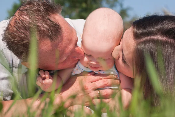 Portrait of happy mother and father with a baby — Stock Photo, Image