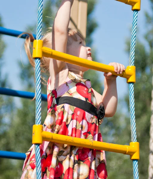Girl climbs on the ladder of child — Stock Photo, Image