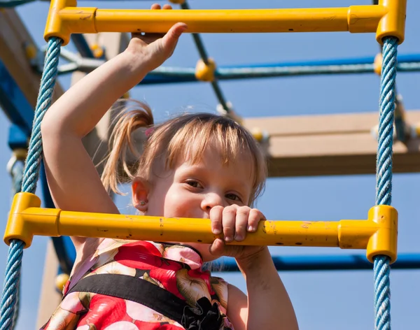 Girl climbs on the ladder of child — Stock Photo, Image