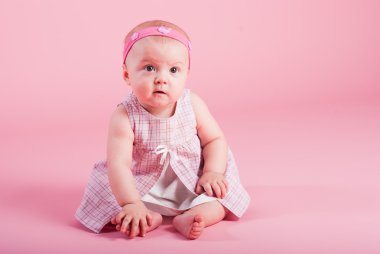 Portrait of the surprised girl on a pink background clipart