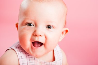 Portrait of the small child on a pink background clipart