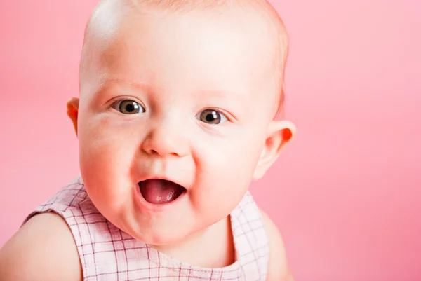 Portrait of the small child on a pink background — Stock Photo, Image