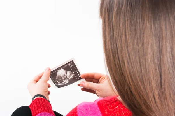 The pregnant woman looks an ultrasound picture — Stock Photo, Image