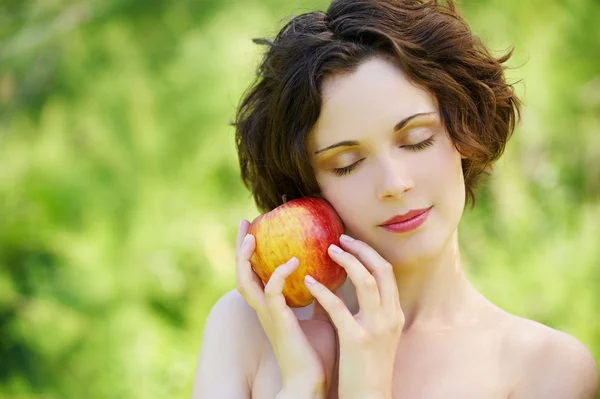 Girl with apple outdoors — Stock Photo, Image
