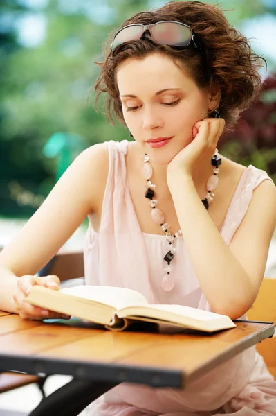 Girl with book outdoors — Stock Photo, Image