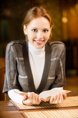 Girl-student reads book. clipart