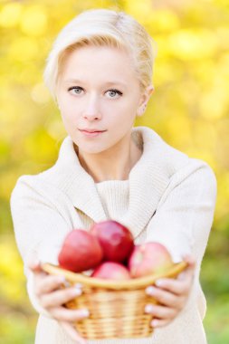 Girl offer basket with apples clipart