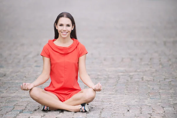 stock image Woman in red dress meditates