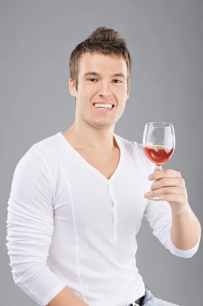 Young man pick up a wineglass — Stock Photo, Image