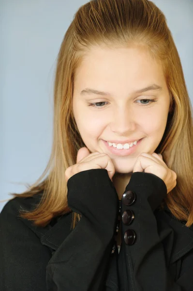 Young smiling girl looks downwards — Stock Photo, Image