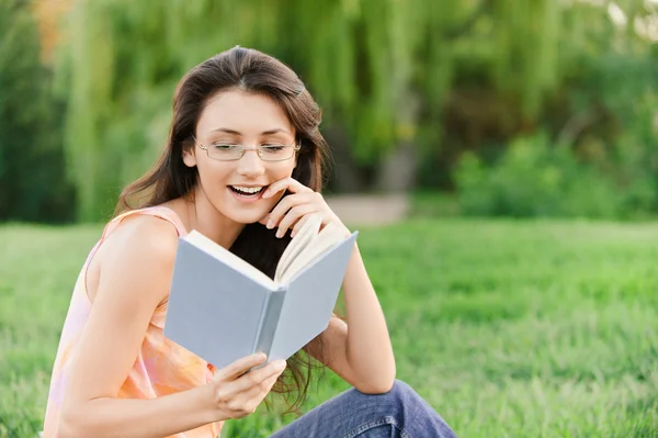 Menina-estudante lê livro didático . — Fotografia de Stock