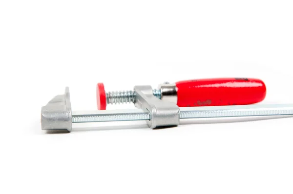 Metal vice with red handle on white background — Stock Photo, Image