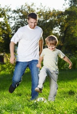 Playful football in park clipart