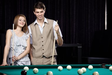 The couple plays billiards clipart