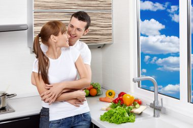 Happy couple at kitchen clipart