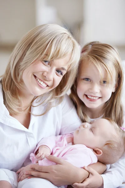 Mom holding the baby in her arms and her daughter — Stock Photo, Image