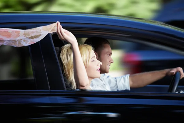 Couple riding in a car — Stock Photo, Image