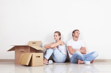 Young Couple with boxes and broken cup clipart