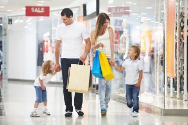Young family with two children in the store clipart