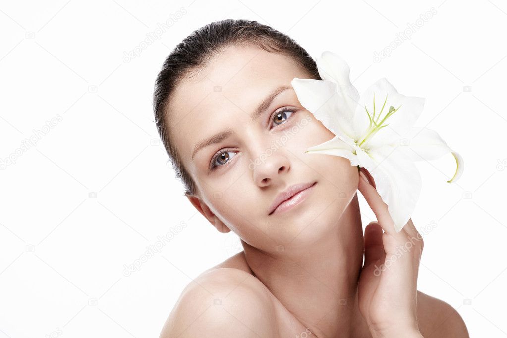 Young attractive girl with a lily on a white background