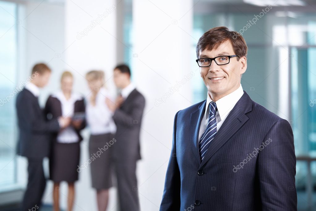 Business man in office compared to other staff