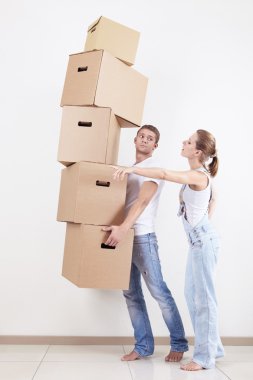 A young girl shows a man where to put the box clipart