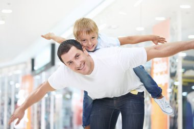 Father and son have fun in store clipart
