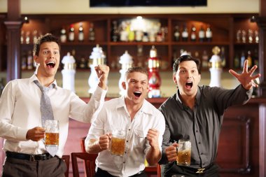 Young men rejoice the victory of his team in a bar clipart