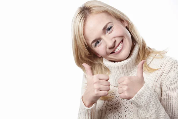 Attractive woman holds a thumbs up — Stock Photo, Image