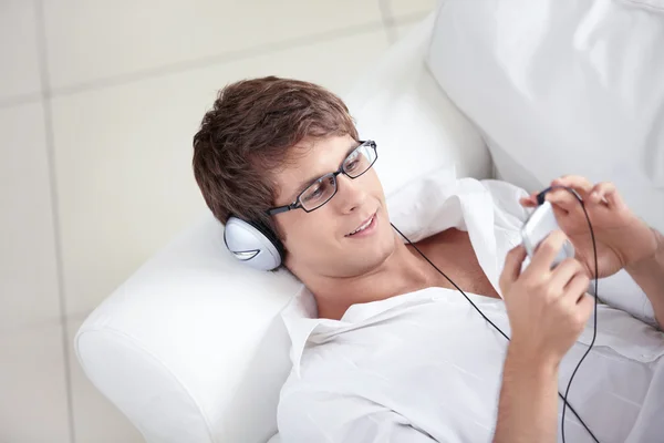 A young man listens to music — Stock Photo, Image