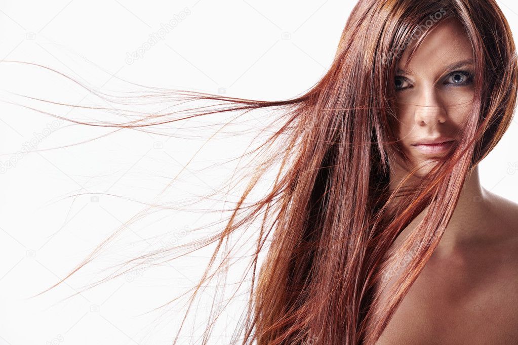 Attractive girl with red hair on a white background
