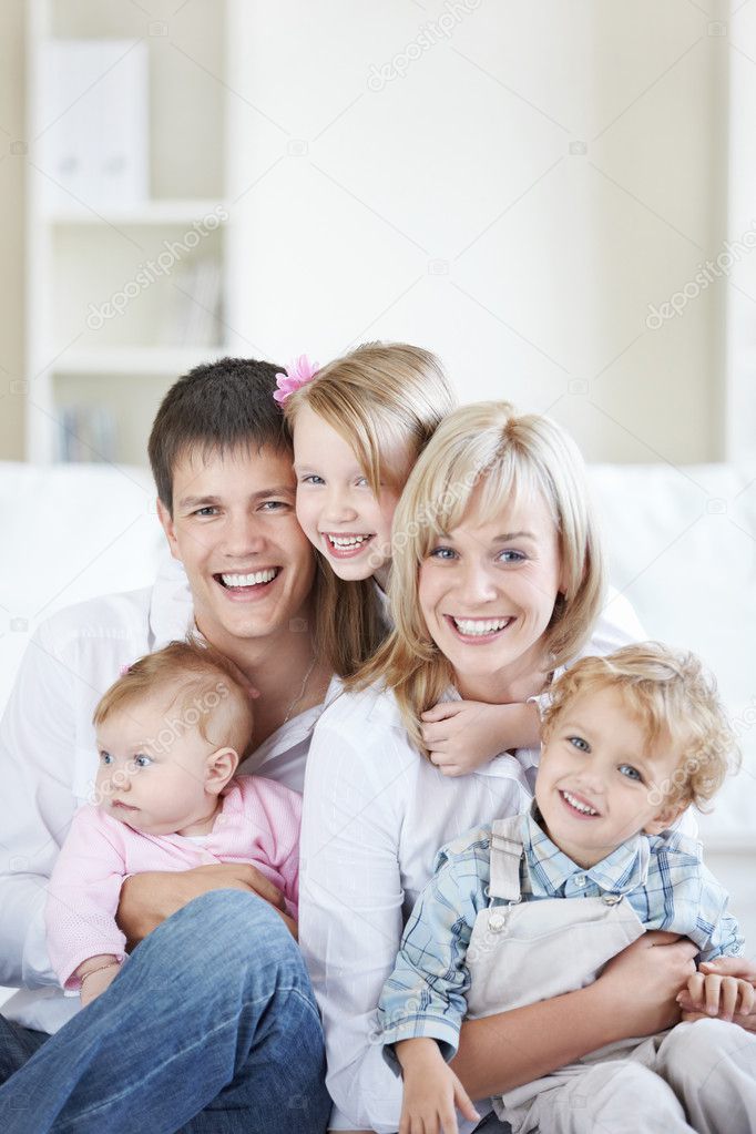 Attractive family with three children at home