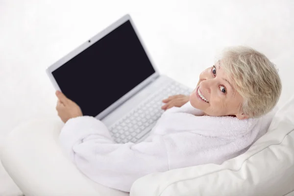 快乐老人女人用一台笔记本电脑 — 图库照片