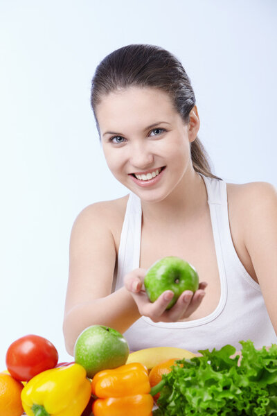 Young attractive girl offers an apple