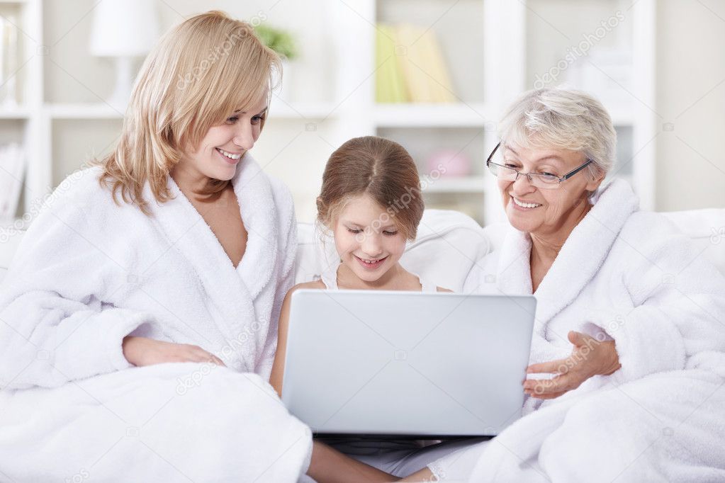 Attractive family is looking into a laptop