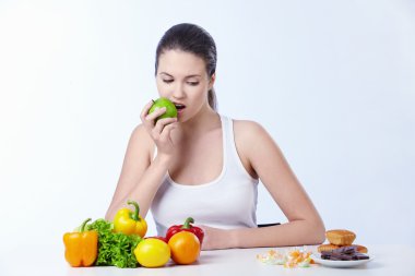 The girl is the apple and looks for dessert on a white background clipart